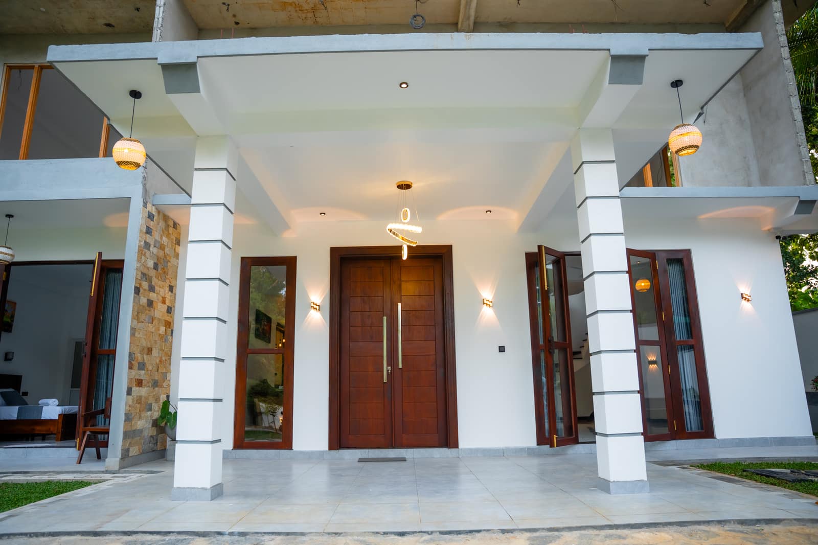 The entrance porch, with its stone-faced column and tall wooden doors